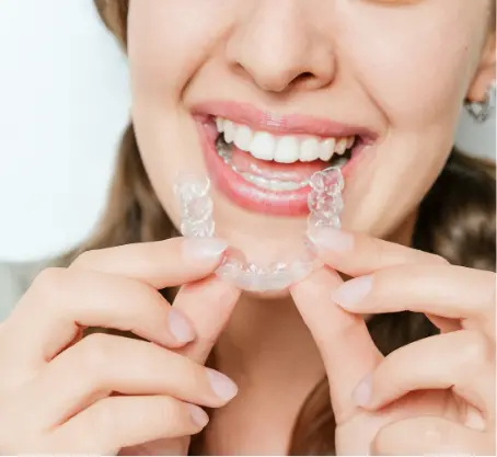 woman inserting clear aligner