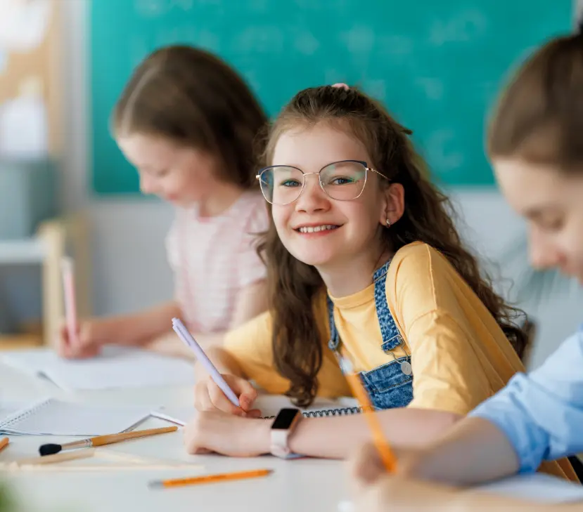 young girl with glasses smiling
