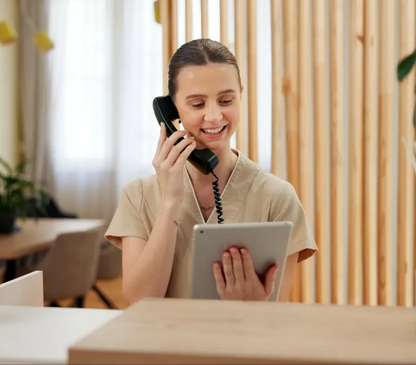 woman on phone looking at tablet